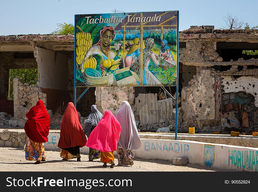 Somali woman walk past a billboard mural saying â€œCultivate to prosperâ€ that was displayed as part of a project to produce and display billboards around Mogadishu designed to mobilise and educate people through art to better understand and absorb the differences, benefits and realities between conflict and peace. During the occupation of the city by the Al-Qaeda-affiliated militant group Al Shabaab up until August 2011, many Somali artists were either forced to work in secret or stop practising their art all together for fear of retribution and punishment by the extremist group who were fighting to overthrow the internationally-recognised then transitional government and implement a strict and harsh interpretation of Islamic Sharia law. After 20 years of near-constant conflict, Mogadishu and large areas of Somalia are now enjoying the longest period of peace in years after sustained military operations by the Somali National Army &#x28;SNA&#x29; backed by the forces of the African Union Mission in Somalia &#x28;AMISOM&#x29; forced Al Shabaab to retreat from many areas of the country precipitating something of a renaissance for Somali artists and business, commerce, sports and civil liberties and freedoms flourishing once again. AU-UN IST PHOTO / STUART PRICE. Somali woman walk past a billboard mural saying â€œCultivate to prosperâ€ that was displayed as part of a project to produce and display billboards around Mogadishu designed to mobilise and educate people through art to better understand and absorb the differences, benefits and realities between conflict and peace. During the occupation of the city by the Al-Qaeda-affiliated militant group Al Shabaab up until August 2011, many Somali artists were either forced to work in secret or stop practising their art all together for fear of retribution and punishment by the extremist group who were fighting to overthrow the internationally-recognised then transitional government and implement a strict and harsh interpretation of Islamic Sharia law. After 20 years of near-constant conflict, Mogadishu and large areas of Somalia are now enjoying the longest period of peace in years after sustained military operations by the Somali National Army &#x28;SNA&#x29; backed by the forces of the African Union Mission in Somalia &#x28;AMISOM&#x29; forced Al Shabaab to retreat from many areas of the country precipitating something of a renaissance for Somali artists and business, commerce, sports and civil liberties and freedoms flourishing once again. AU-UN IST PHOTO / STUART PRICE.