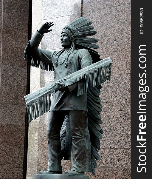 This statue is of Sitting Eagle or John Hunter is located on the corner of 7 Avenue and 6 Street SW in downtown Calgary, Alberta. This statue is of Sitting Eagle or John Hunter is located on the corner of 7 Avenue and 6 Street SW in downtown Calgary, Alberta.