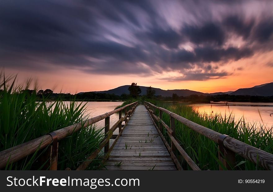 A bridge over a narrow strait or river at sunset. A bridge over a narrow strait or river at sunset.
