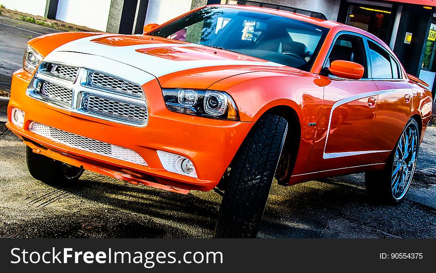 A close up of an orange muscle car.