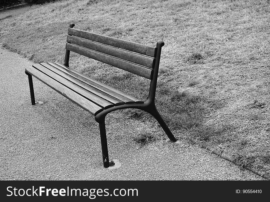 A park bench in black and white.