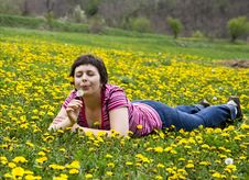 Young Woman Lying In A Meadow Stock Photography