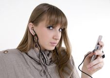 Female Model With Cellphone And Headphones Stock Photography