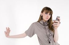Female Model With Cellphone And Headphones Royalty Free Stock Photography