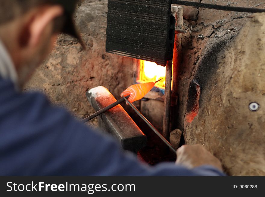 A man shaping a glass bead