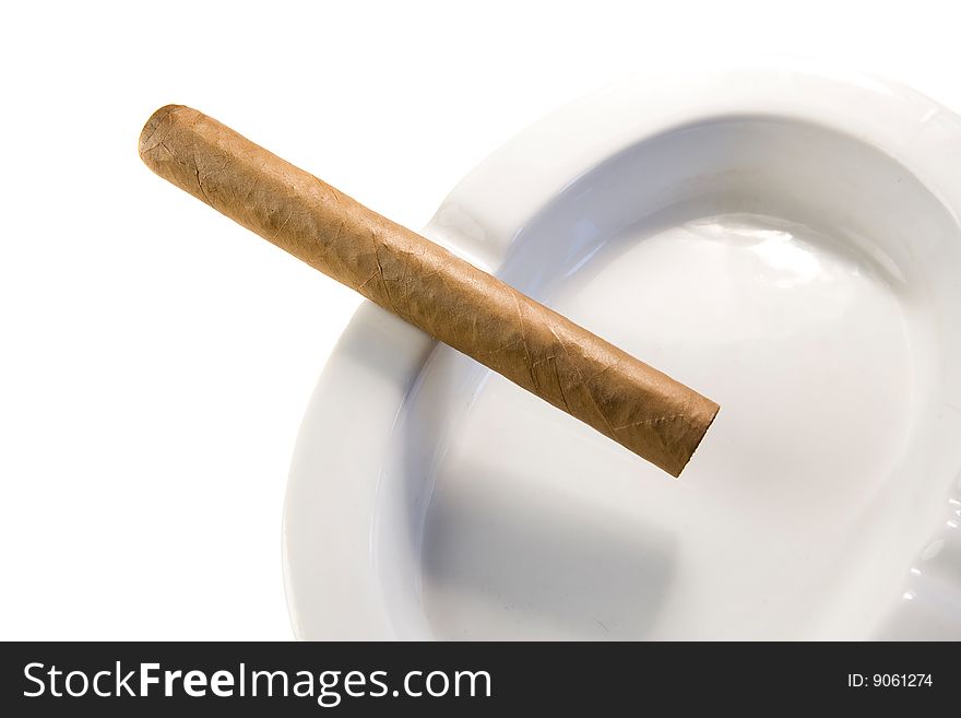 Dominican cigar on white ashtray