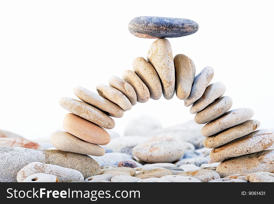Arch of the pebbles with a black stone on top. Arch of the pebbles with a black stone on top