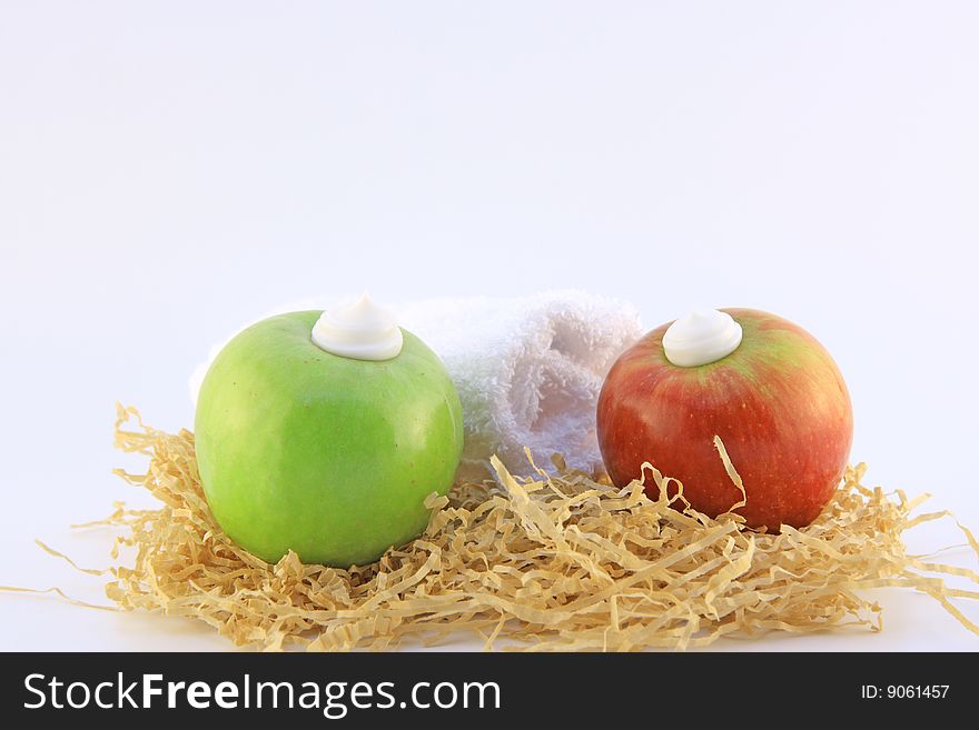 Two apples and cream isolated on white