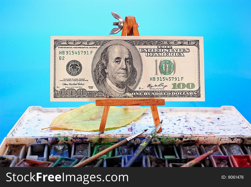 Image of dollar bill as a picture on a miniature easel. Image of dollar bill as a picture on a miniature easel