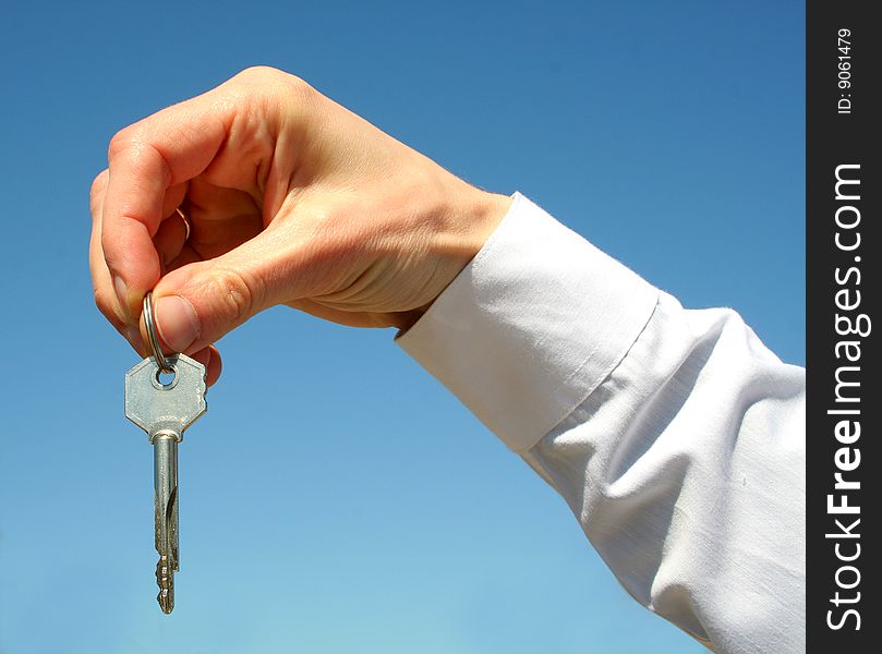 Key in a palm over white background