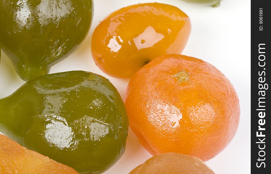 Coloured candied fruits on a white background