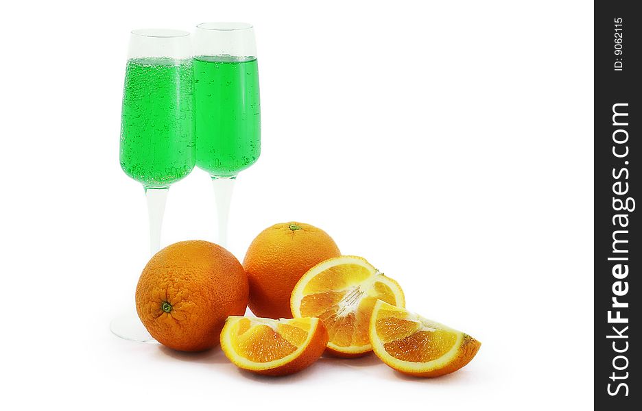 Oranges and glasses with green drink. Oranges and glasses with green drink