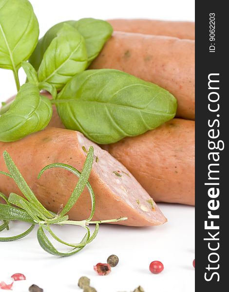 Detail of sausages with basil, rosemary and pepper