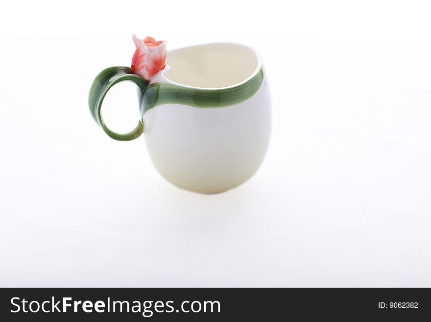 Isolated cup decorated with red flower and green stripe. Isolated cup decorated with red flower and green stripe