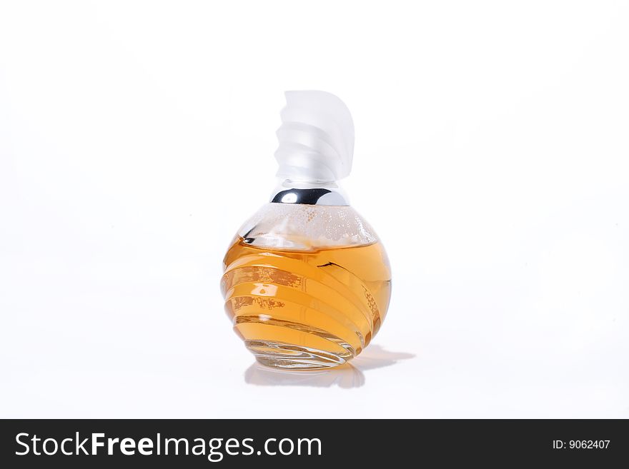 Bottle of yellow perfume. Isolated object on white background. Bottle of yellow perfume. Isolated object on white background