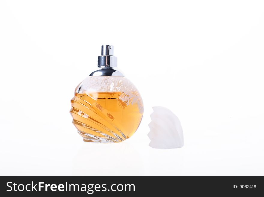 Open bottle of yellow perfume. Isolated object on white background. Open bottle of yellow perfume. Isolated object on white background