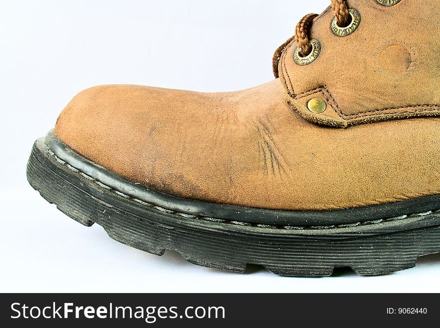 A pair of hiking boots isolated on white background. Shallow depth of field