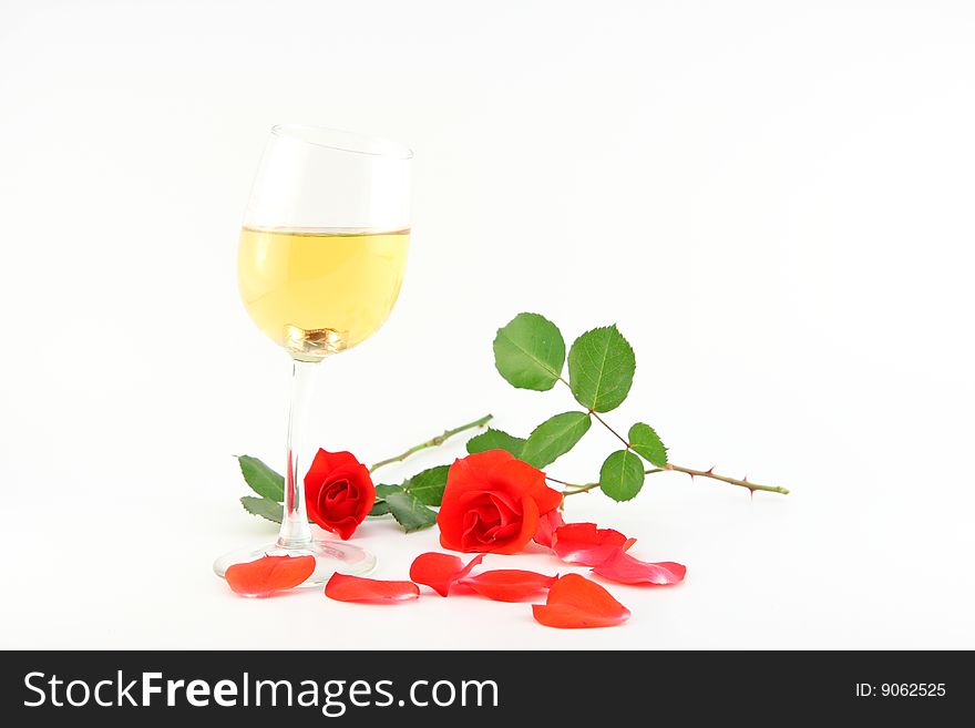The glass with wine and roses isolated on white. The glass with wine and roses isolated on white
