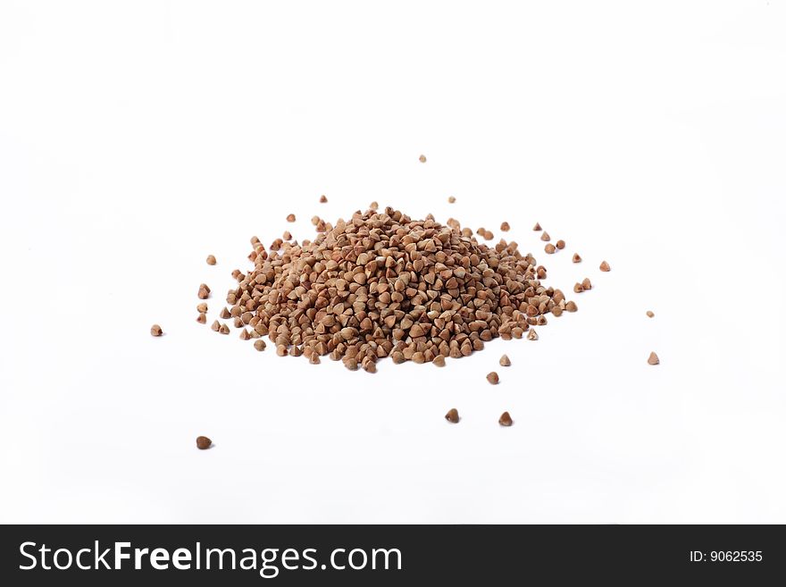 Isolated buckwheat on white background. Handful of grain