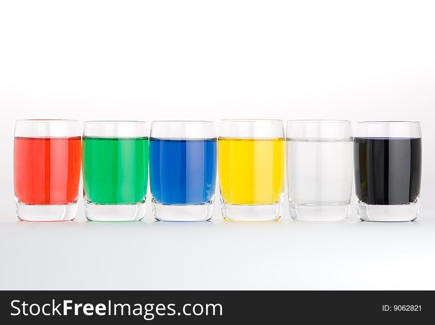 Glasses with colored water on white background. Glasses with colored water on white background