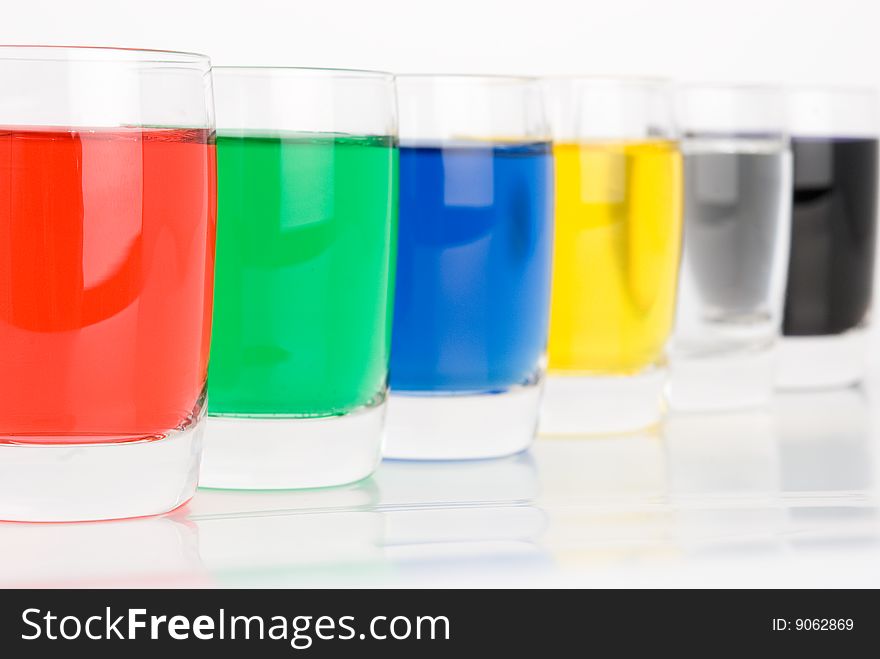 Glasses with colored water on white background. Glasses with colored water on white background