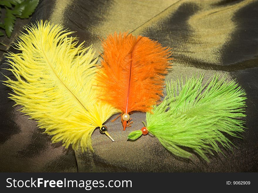 Feather confetti in bright orange, green and yellow