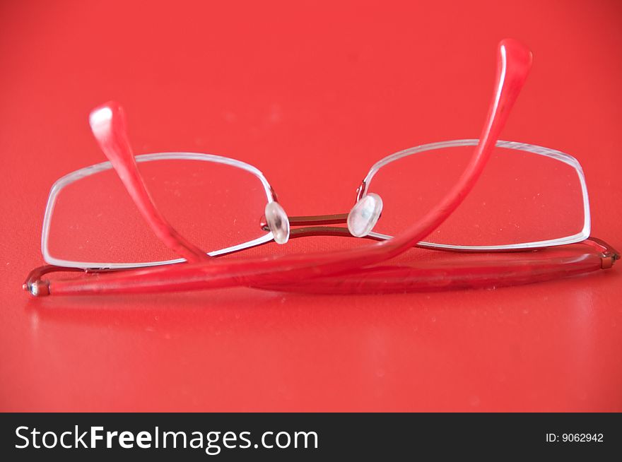 Optical  glasses  with red frame on a red background
