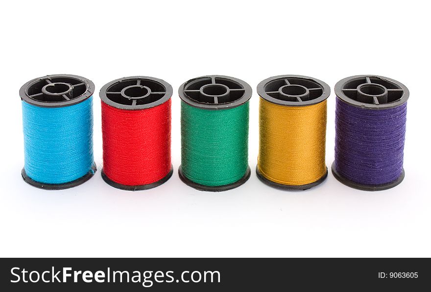 Five colouful bobbins with cotton thread. Five colouful bobbins with cotton thread