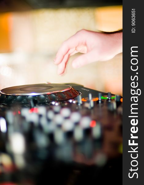 Close-up of deejay's hand and turntable, selective focus