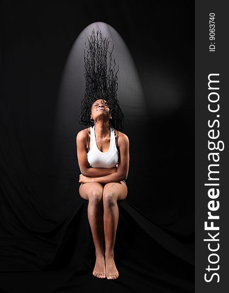 Fine art portrait of afro-american woman with long flapping hairs against black background. Fine art portrait of afro-american woman with long flapping hairs against black background