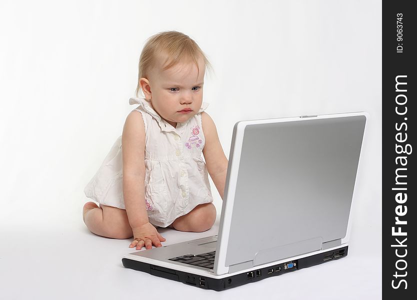 Little girl looking on the laptop