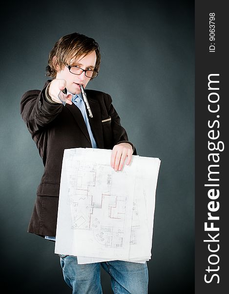 Young architect with sketch, studio shot
