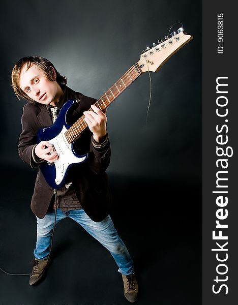 Young man playing electro guitar, high angle view