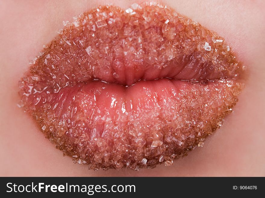 Woman's red lips coated with scattered sugar. Woman's red lips coated with scattered sugar
