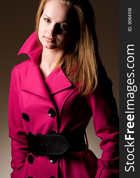 Young fashionable woman wearing purple coat