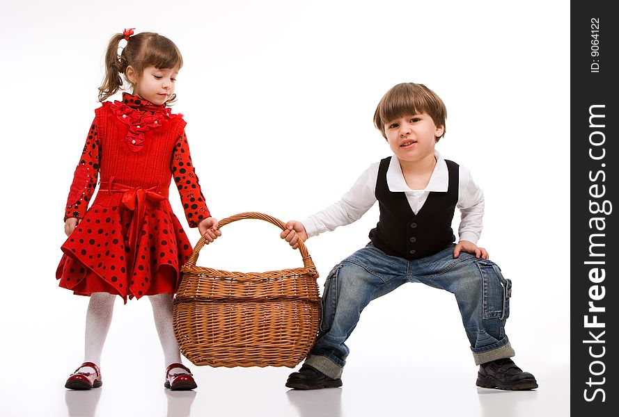 Two beautiful children with basket, isolated on white