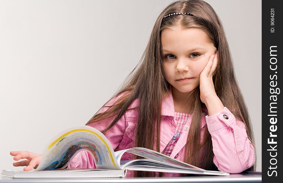 Happy little girl reading open book. Happy little girl reading open book