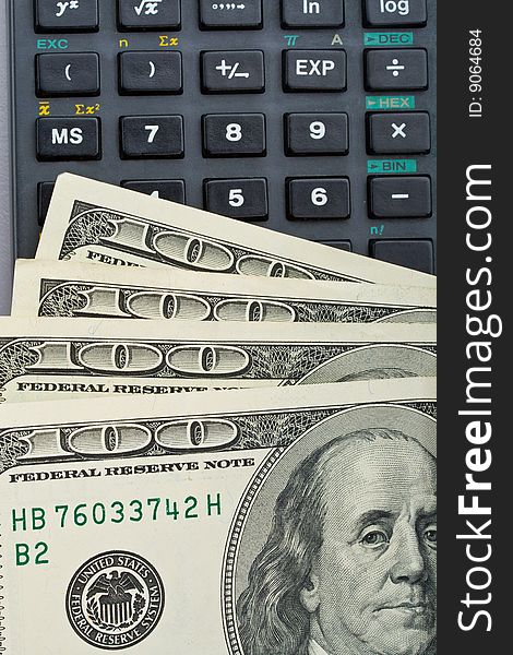 Close-up many dollars over calculator. Close-up many dollars over calculator