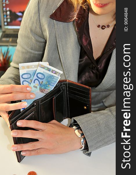 Young business woman, showing money taken from the wallet