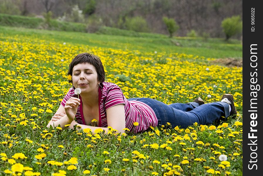 Young woman lying in a meadow