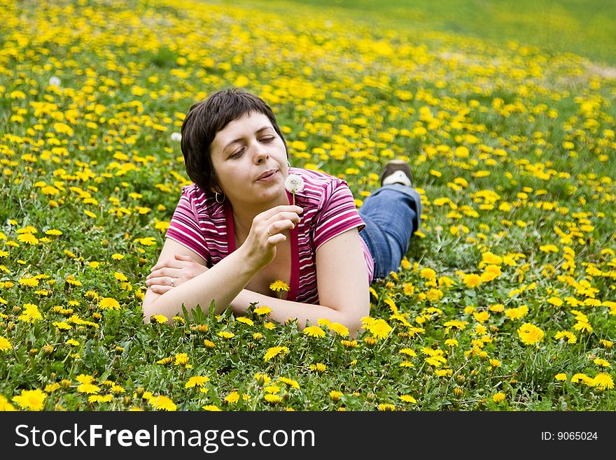 Young woman lying in a meadow