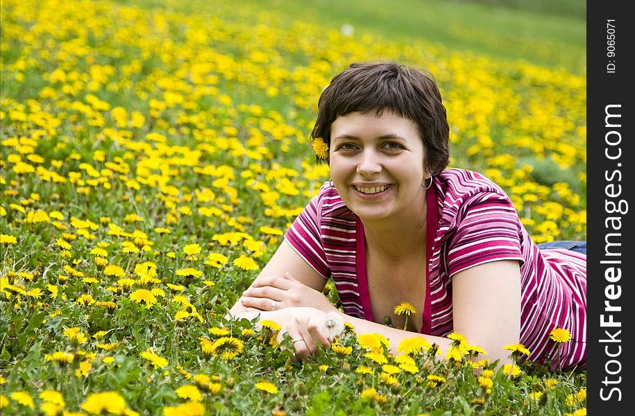 Young woman lying in a meadow