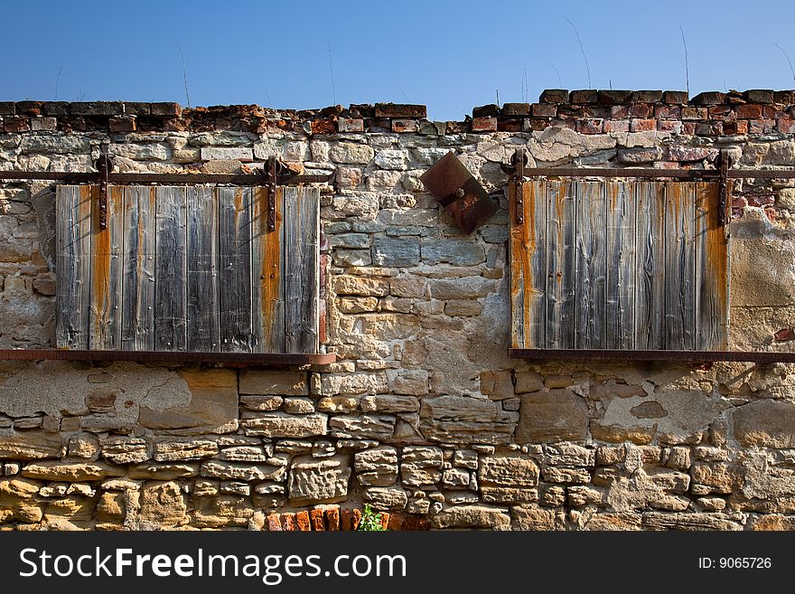 Rolling windows on an ruin farm wall