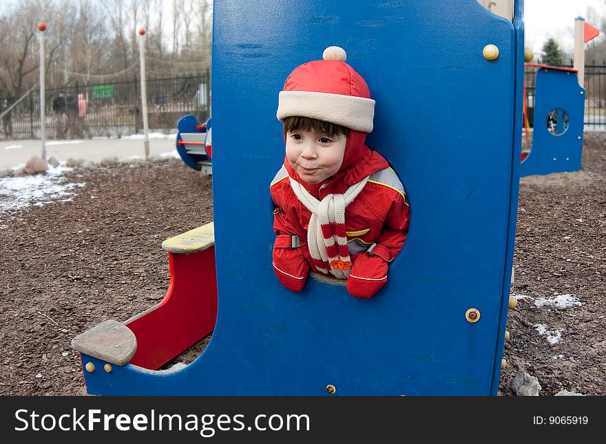 Fish-eye comical portrait of the little girl on a playground