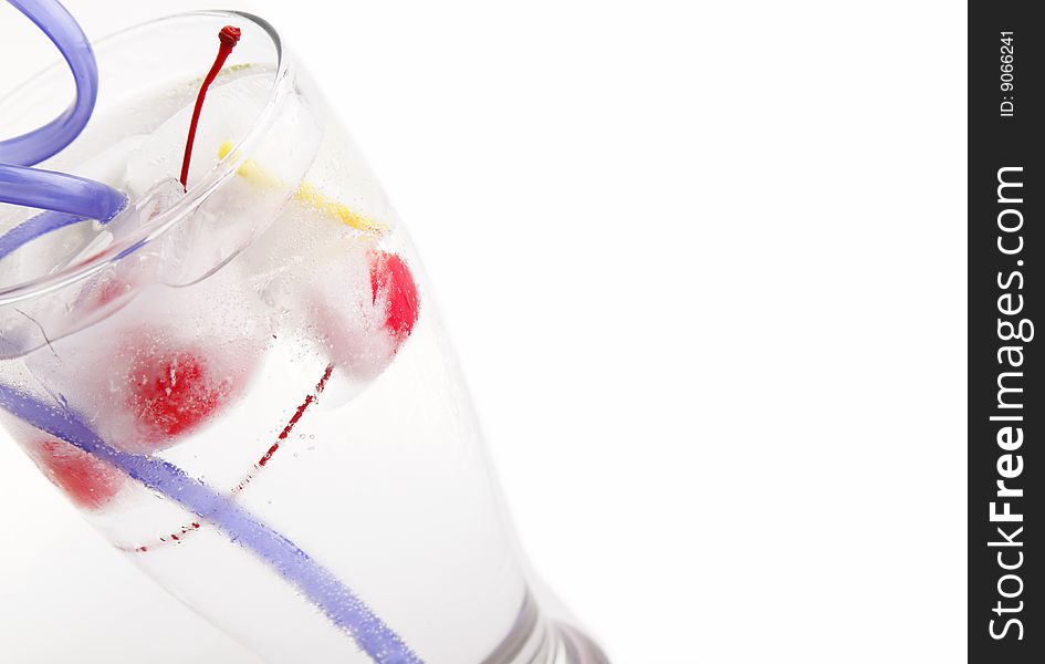 Glass of water with frozen fruit inside the ice cube. Glass of water with frozen fruit inside the ice cube