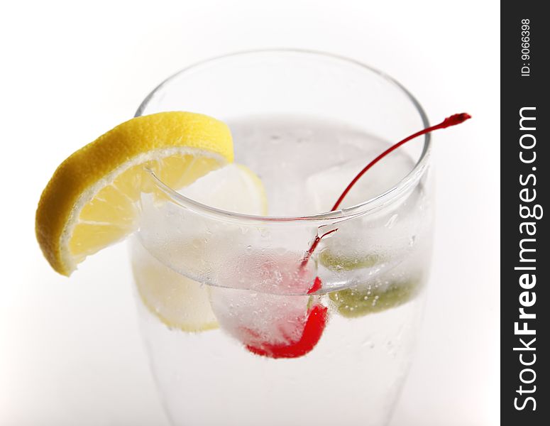 Glass of water with frozen fruit inside the ice cube. Glass of water with frozen fruit inside the ice cube