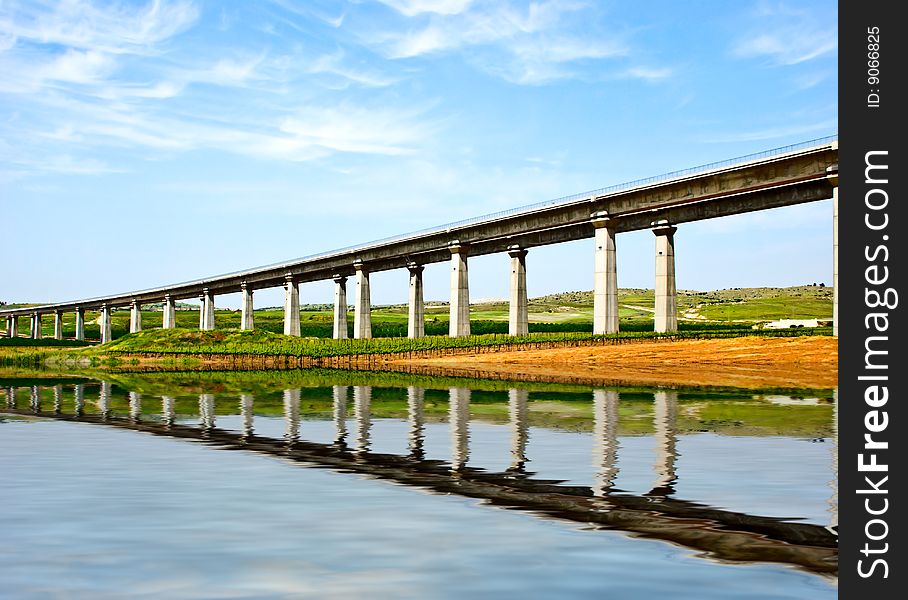 A huge high concrete train bridge under construction.