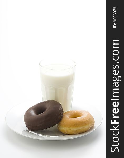 Breakfast glass of chocolate milk and donut isolated