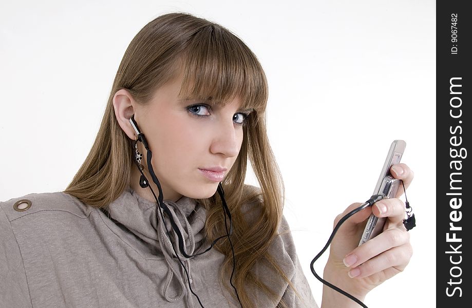 Pretty female model with cellphone and headphones