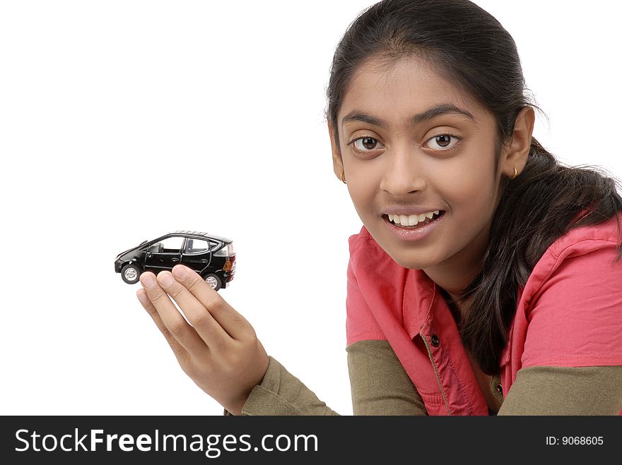 Beautiful girl holding black car model over white background. Beautiful girl holding black car model over white background